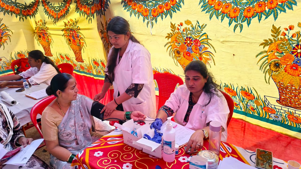 Foundation nurse checking a patient's blood pressure at a free health camp